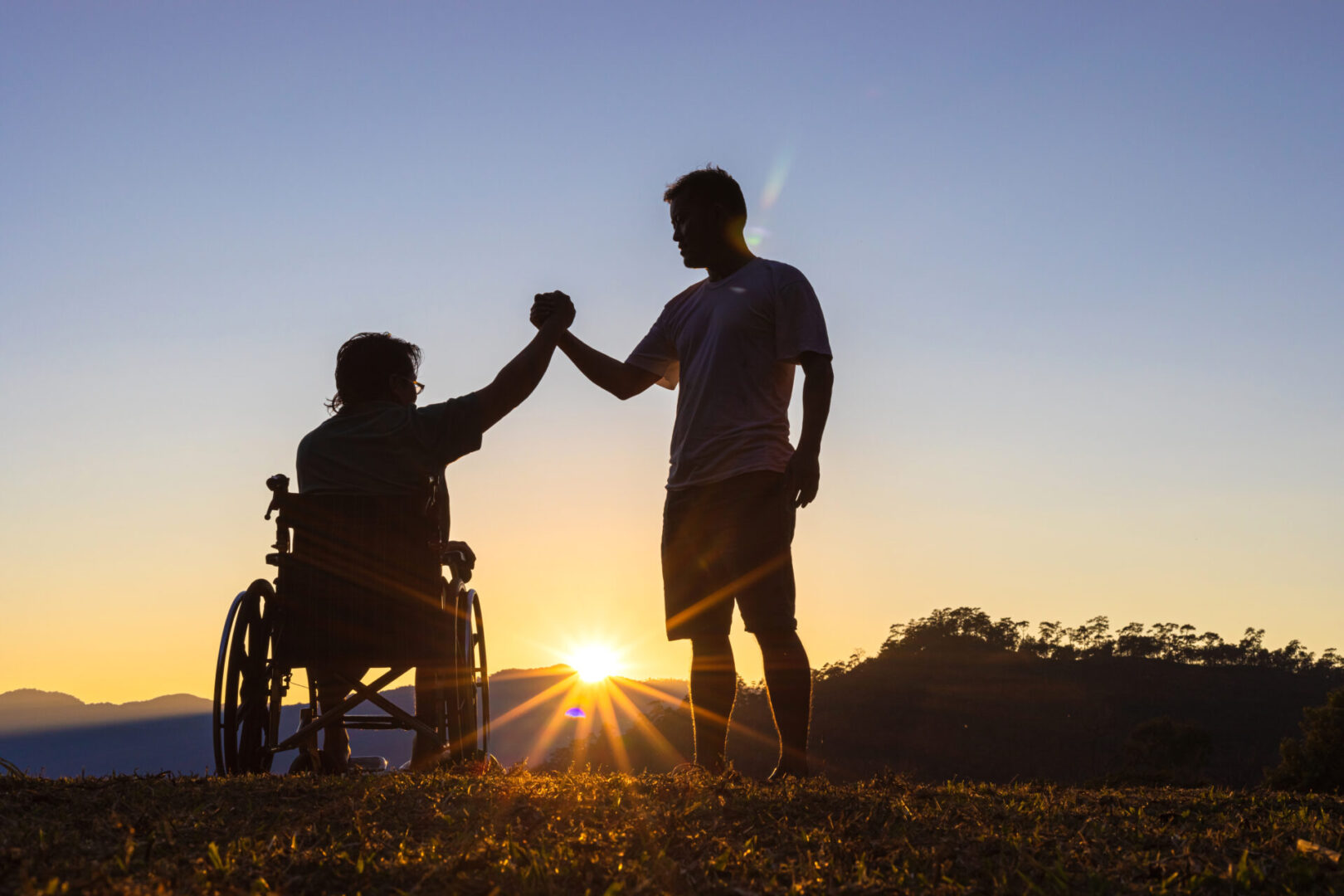 Silhouette,Of,Joyful,Disabled,Man,In,Wheelchair,Raised,Hands,With